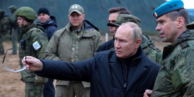 FILE - Russian President Vladimir Putin, second right, gestures as he visits a Western Military District military training center for mobilized reservists in the Ryazan region, Russia, with Deputy Airborne Forces Commander Anatoly Kontsevoy, right, October 14.  20th, 2022. 