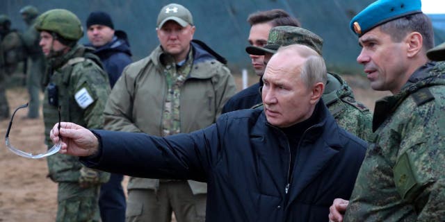 FILE - Russian President Vladimir Putin, second right, gestures as he visits with Deputy Commander of the Airborne Troops Anatoly Kontsevoy, right, a military training center of the Western Military District for mobilised reservists in Ryazan Region, Russia, on Oct. 20, 2022. 