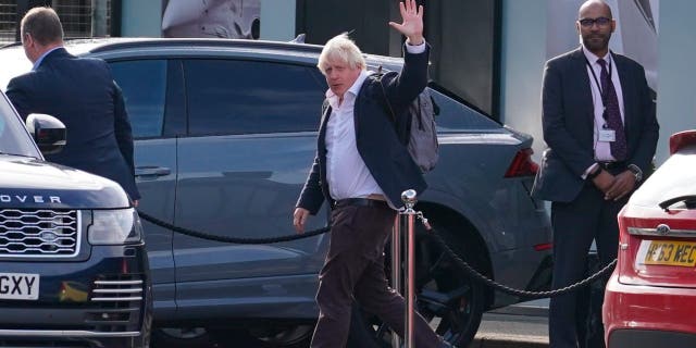 Former Prime Minister Boris Johnson arrives at Gatwick Airport in London, after travelling on a flight from the Caribbean, following the resignation of Liz Truss as Prime Minister, Saturday Oct. 22, 2022.