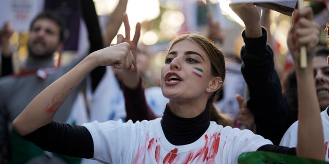 A woman screams during a protest against the Iranian regime, in Berlin, Germany, on Saturday 22 October 2022, following the death of Mahsa Amini in the custody of the infamous "moral police."