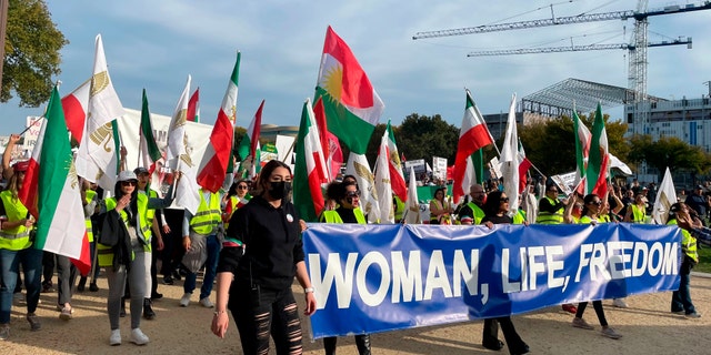 People have signs that say "women, life, freedom," Hundreds of people rallied in Washington on Saturday, October 22, 2022, to express international support for demonstrators facing a violent government crackdown in Iran. It stems from the death of her 22-year-old Masa Amini, who was in custody of the Iranian moral police.  . 