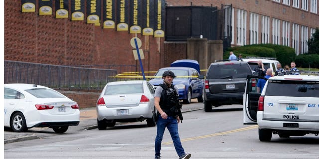 Officers investigate a shooting at Central Visual and Performing Arts High School Monday, Oct. 24, 2022, in St. Louis.