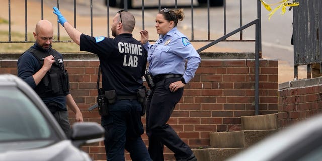 Law enforcement investigate the scene of a shooting at Central Visual and Performing Arts High School Monday, Oct. 24, 2022, in St. Louis.