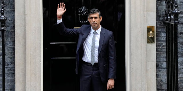 British Prime Minister Rishi Sunak waves from the steps of 10 Downing Street in London, Tuesday, Oct. 25, 2022. New British Prime Minister Rishi Sunak arrived at Downing Street Tuesday after returning from Buckingham Palace where he was invited to form a government by Britain's King Charles III. 