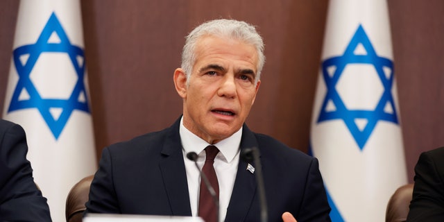 FILE - Israeli Prime Minister Yair Lapid attends a cabinet meeting at the prime minister's office in Jerusalem, Sunday, Oct. 23, 2022. Israel is holding its fifth national election in under four years, and once again the race is shaping up as a referendum on former Prime Minister Benjamin Netanyahu’s fitness to rule.  (Abir Sultan/Pool Photo via AP, File)