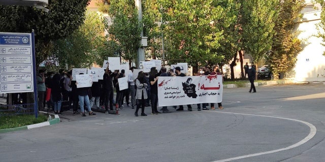 In this photo taken by an individual not employed by the Associated Press and obtained by the AP outside Iran shows students of the Sharif University of Technology attend a protest sparked by the death in September of 22-year-old Mahsa Amini in the custody of the country's morality police, in Tehran, Friday, Oct. 7, 2022. The banner says: 