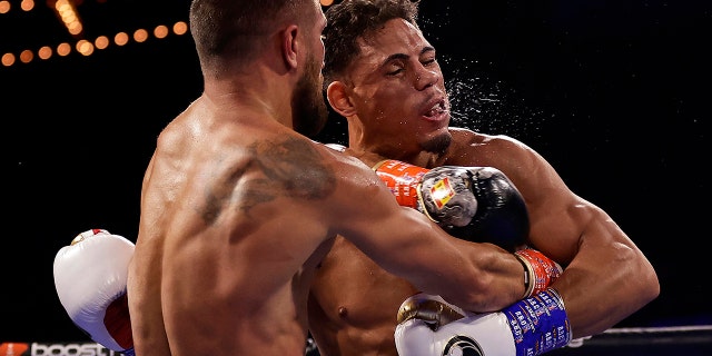 Vasiliy Lomachenko punches Jamaine Ortiz, right, during a lightweight boxing match Saturday, Oct. 29, 2022, in New York.