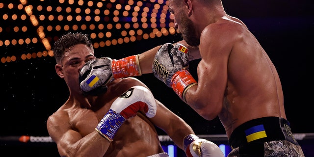 Vasiliy Lomachenko, right, punches Jamaine Ortiz during a lightweight boxing match Sunday, Oct. 30, 2022, in New York. 
