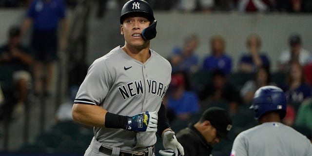 New York Yankees slugger Aaron Judge heads to the dugout after grounding out during the first inning of the first game of a doubleheader against the Texas Rangers in Arlington, Texas, on Tuesday.