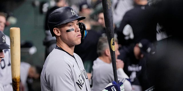 New York Yankees' Aaron Judge stands in the dugout before Game 1 of baseball's American League Championship Series between the Houston Astros and the New York Yankees on Wednesday, Oct. 19, 2022 in Houston.