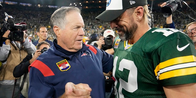 Head coach Bill Belichick of the New England Patriots, left, and Aaron Rodgers of the Green Bay Packers talk after Green Bay's 27-24 win in overtime at Lambeau Field on Oct. 2, 2022, in Green Bay, Wisconsin.