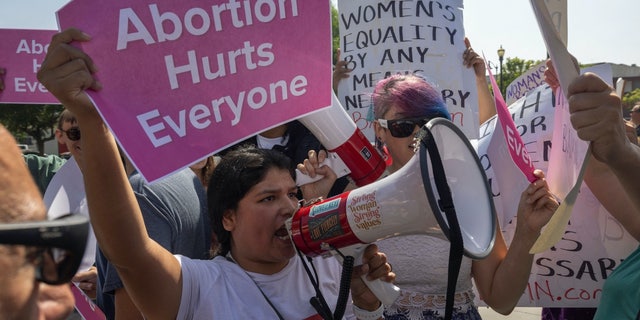 A group of pro-life protesters crashes the Women's March Action Rally for Reproductive Rights at Mariachi Plaza in Los Angeles, California, on Oct. 8, 2022.