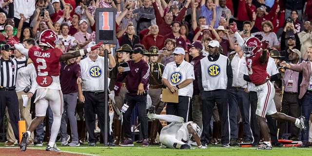 Alabama defensive backs DeMarcco Hellams and Terrion Arnold signal no catch on the final play against Texas, Saturday, Oct. 8, 2022, in Tuscaloosa.