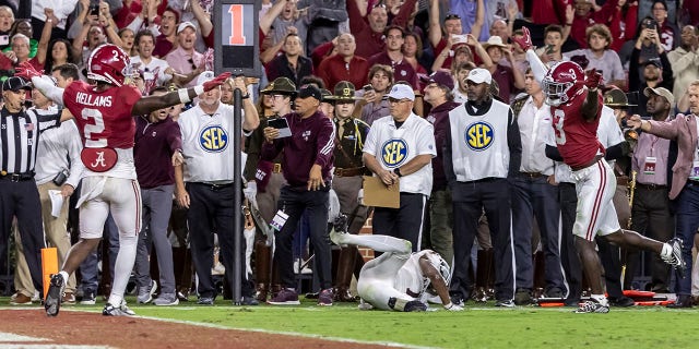Alabama defensive backs DeMarco Hellams and Terrion Arnold signal no catch on the final play against Texas, Saturday, Oct. 8, 2022, in Tuscaloosa.