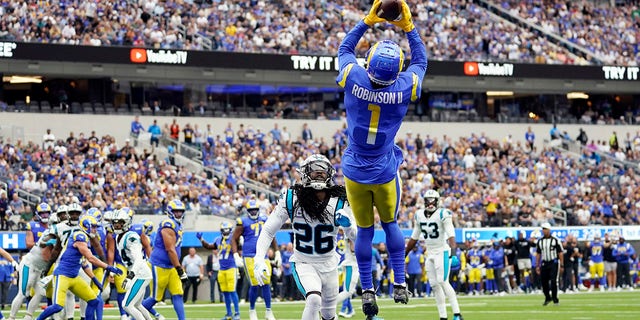 Los Angeles Rams wide receiver Allen Robinson II (1) makes a touchdown catch over Carolina Panthers cornerback Donte Jackson (26) during the first half of an NFL football game Sunday, Oct. 16, 2022, in Inglewood, Calif. 