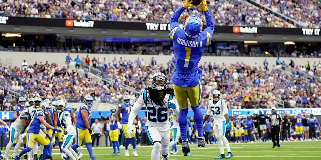 Los Angeles Rams wide receiver Allen Robinson II (1) makes a touchdown catch over Carolina Panthers cornerback Donte Jackson (26) during the first half of an NFL football game Sunday, Oct. 16, 2022, in Inglewood, Calif.