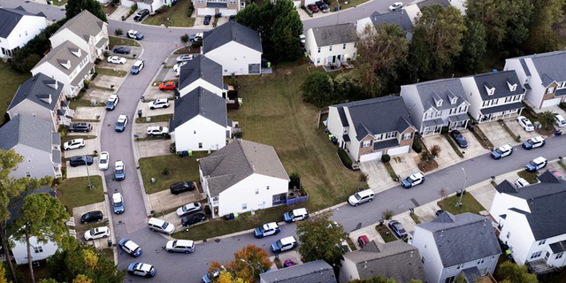 In this aerial image taken with a drone, law enforcement works at the scene of a shooting in Raleigh, N.C., Thursday, Oct. 13, 2022.