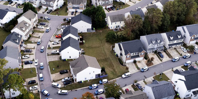 In this aerial image taken with a drone, law enforcement works at the scene of a shooting in Raleigh, N.C., Thursday, Oct. 13, 2022.