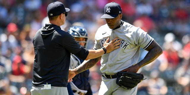 Aroldis Chapman of the New York Yankees is taken out of the game by manager Aaron Boone during the Guardians game at Progressive Field on July 2, 2022, in Cleveland, Ohio.