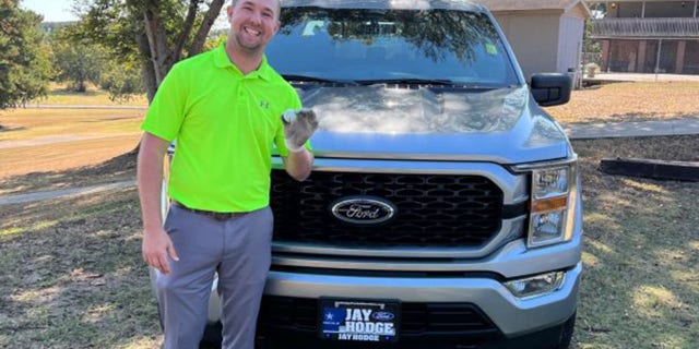 Austin Clagett poses with his hole-in-one ball and what he thought would be his prize.