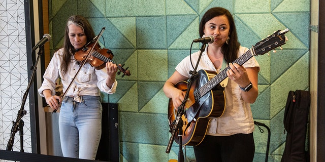 FILE: A two-person country band performs live music in the west terminal on May 23, 2022, in Austin, Texas. 