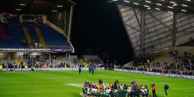 Fiji's players and team members pray at the end of the Rugby League World Cup match between Australia and Fiji at the Headingley Stadium, Leeds, England, Saturday, Oct. 15, 2022.