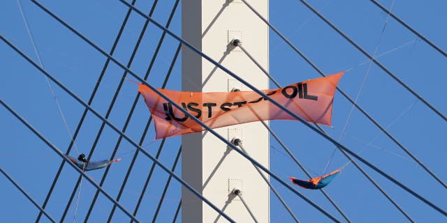 Just Stop Oil protesters continue their second day protest on the Queen Elizabeth II Bridge, which connects Kent and Essex.  The bridge remains closed to traffic, after being climbed by two climbers from the group.  Image date: Tuesday October 18, 2022.