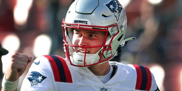 New England Patriots' Bailey Zappe pumps his fist following a touchdown.