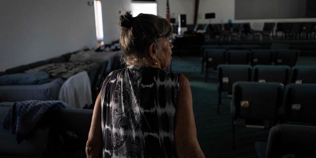 Barbara Wasco walks through the sanctuary of Southwest Baptist Church in Fort Myers, Florida on October 2, 2022. When Hurricane Her Ian hit Southwest Florida, she took refuge inside a church.  (AP Photo/Robert Bumsted)