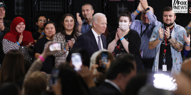 Joe Biden greets employees of an IBM facility.