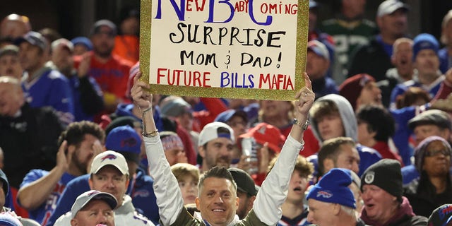 A fan displays a sign during the game between the Green Bay Packers and the Buffalo Bills at Highmark Stadium on October 30, 2022 in Orchard Park, New York.