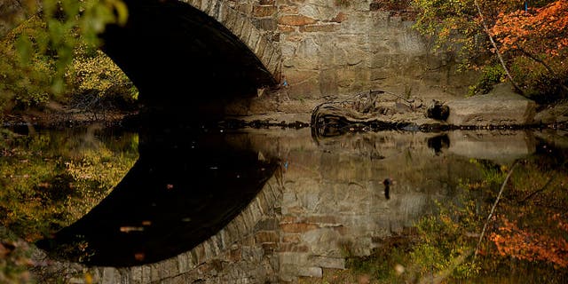 Fall color reflections at the Blackstone River in Whitinsville, Massachusetts. 