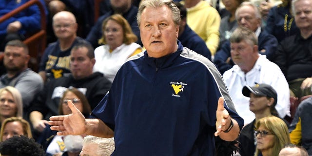 Bob Huggins, head coach of the West Virginia Mountaineers, watches the Shriners Children's Charleston Classic College basketball game against the Marquette Golden Eagles at TD Arena in Charleston, South Carolina on November 19, 2021.