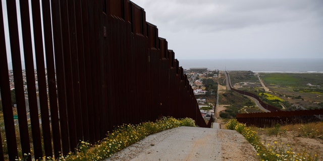New sections of the steel bollard-style border wall, comprising primary and secondary barriers, stands along the US-Mexico border between San Diego and Tijuana 