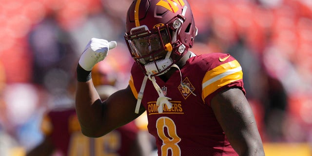 Washington Commanders running back Brian Robinson Jr. gestures as he warms up before an NFL football game against the Tennessee Titans, Sunday, Oct. 9, 2022, in Landover, Maryland.