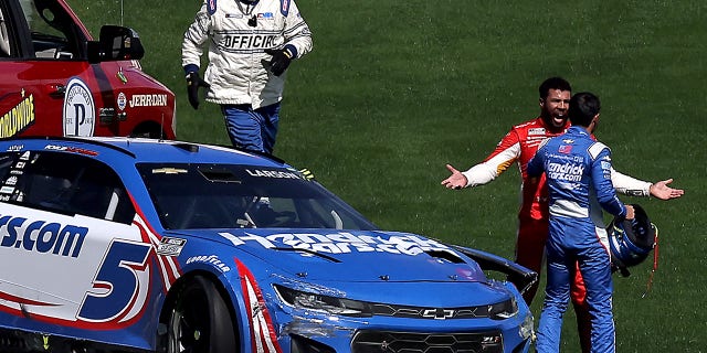 Bubba Wallace, driver of the #45 McDonald's Toyota, confronts Kyle Larson, driver of the #5 HendrickCars.com Chevrolet, after an on-track incident during the NASCAR Cup Series South Point 400 at Las Vegas Motor Speedway on October 16, 2022, in Las Vegas, Nevada.