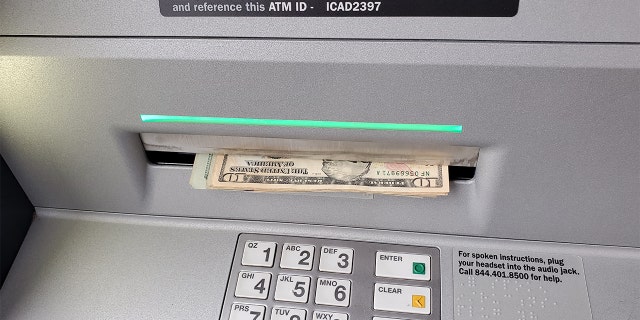 An ATM dispensing cash in Lafayette, California, Dec.22, 2021.