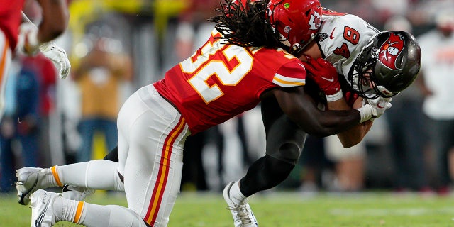 Kansas City Chiefs linebacker Nick Bolton tackles Tampa Bay Buccaneers tight end Cameron Brate during the game on Sunday at Raymond James Stadium in Tampa, Florida.
