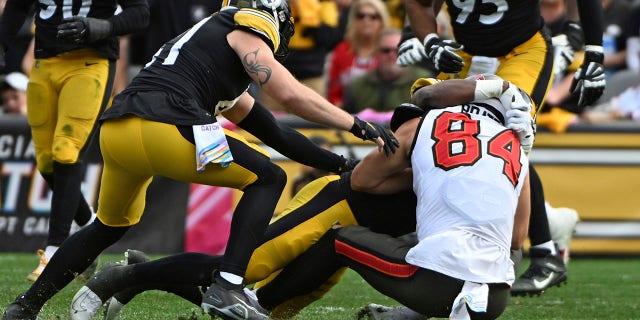 Tampa Bay Buccaneers tight end Cameron Brate, #84, is tackled by Pittsburgh Steelers linebacker Myles Jack, #51, during the second half of an NFL football game in Pittsburgh, Sunday, Oct. 16, 2022.