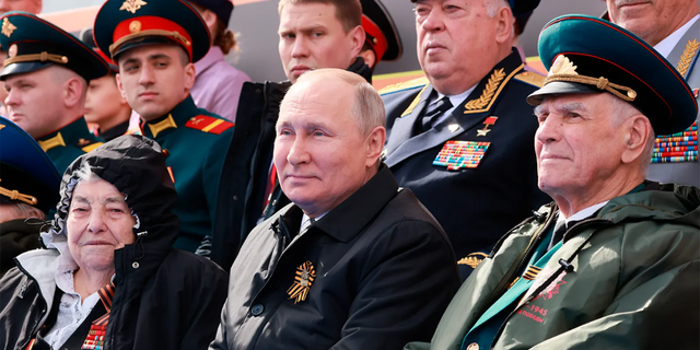 Russian President Vladimir Putin, center, attends the Victory Day military parade marking the 77th anniversary of the end of World War II in Moscow on May 9, 2022.