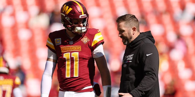 Ron Rivera on why Commanders have fallen behind in NFC East: 'Quarterback' 3 Carson Wentz #11 of the Washington Commanders talks with Offensive Coordinator Scott Turner prior to the game against the Tennessee Titans at FedExField on Oct. 9, 2022 in Landover, Maryland.