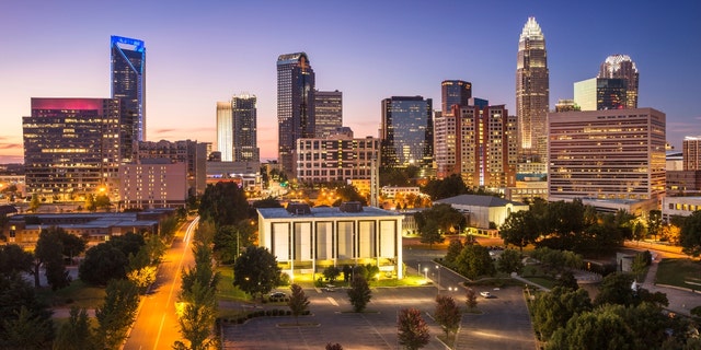 A photo of lit buildings forming the skyline of Charlotte, North Carolina.