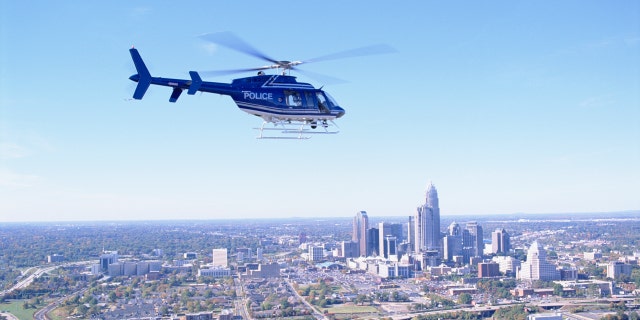 A police helicopter flies over Charlotte, North Carolina.