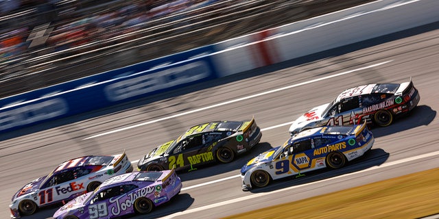 Denny Hamlin, driver of the No. 11 FedEx Express Toyota, Daniel Suarez, driver of the No. 99 Tootsies Orchid Lounge Chevrolet, William Byron, driver of the No. 24 RaptorTough.com Chevrolet, Chase Elliott, driver of the No. 9 NAPA Auto Parts Chevrolet, and Cole Custer, driver of the No. 41 HaasTooling.com Ford, race during the YellaWood 500 at Talladega Superspeedway on Oct. 2, 2022, in Talladega, Alabama.