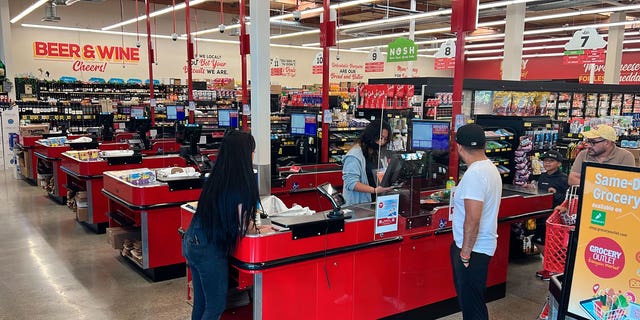 Customers check out at a Grocery Outlet store in Pleasanton, Calif. on Thursday, Sept. 15, 2022.  "Best before" labels are coming under scrutiny as concerns about food waste grow around the world. Manufacturers have used the labels for decades to estimate peak freshness. But "best before" labels have nothing to do with safety, and some worry they encourage consumers to throw away food that’s perfectly fine to eat.  (AP Photo/Terry Chea)