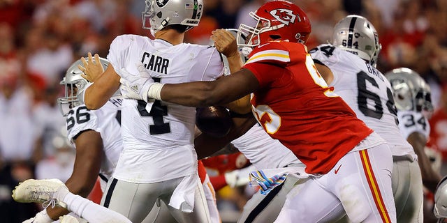 Derek Carr #4 of the Las Vegas Raiders is sacked by Chris Jones #95 of the Kansas City Chiefs during the 2nd quarter of the game at Arrowhead Stadium on October 10, 2022 in Kansas City, Missouri. 