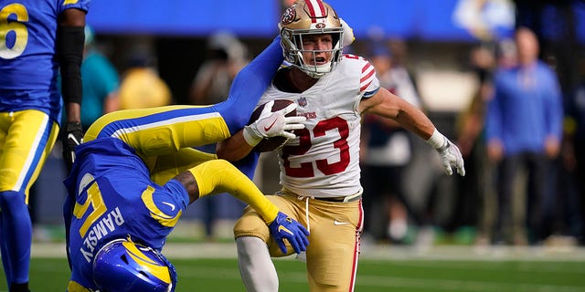San Francisco 49ers running back Christian McCaffrey, right, gets up after being tackled by Los Angeles Rams cornerback Jalen Ramsey during the first half, Oct. 30, 2022, in Inglewood, California.