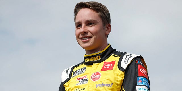 Christopher Bell, driver of the No. 20 DeWalt Toyota, walks onstage during driver intros before the NASCAR Cup Series Bank of America Roval 400 at Charlotte Motor Speedway Oct. 9, 2022, in Concord, N.C.