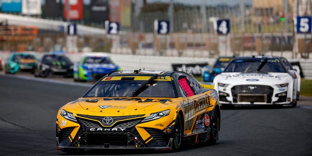 Christopher Bell, driver of the No. 20 DeWalt Toyota, leads the field during the NASCAR Cup Series Bank of America Roval 400 at Charlotte Motor Speedway Oct. 9, 2022, in Concord, N.C.