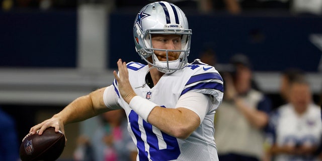 Dallas Cowboys quarterback Cooper Rush warms up before the first half of an NFL football game against the Washington Commanders in Arlington, Texas, Sunday, Oct. 2, 2022.